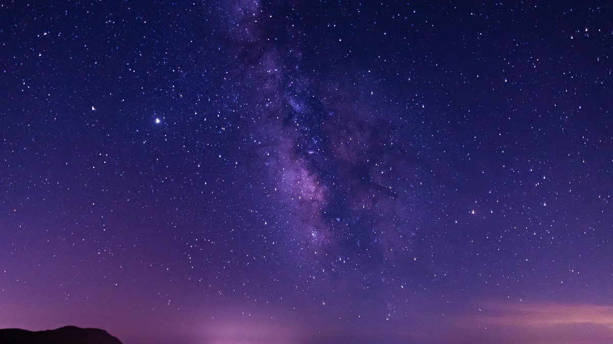 紫色の夜空に広がる天の川