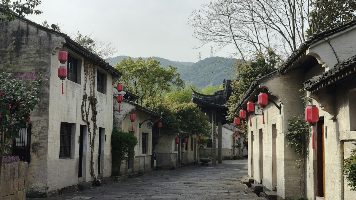 赤い提灯の下がる古い中国の村の石畳の路地