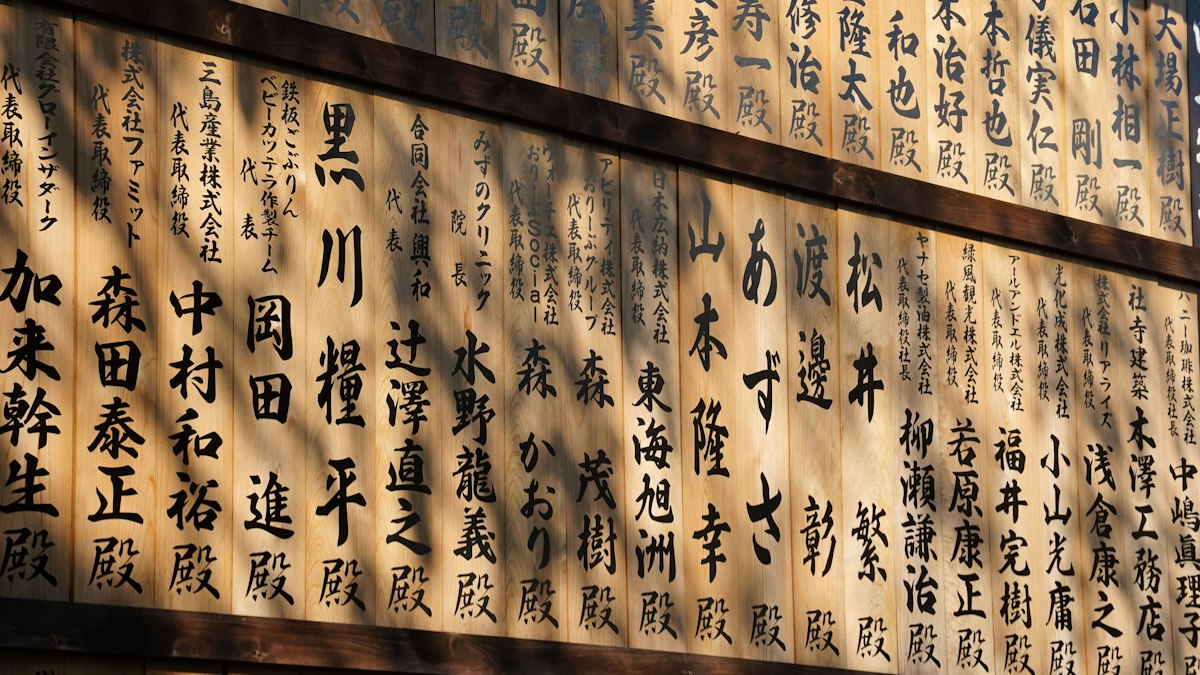 縦書きの漢字が並ぶ木の壁